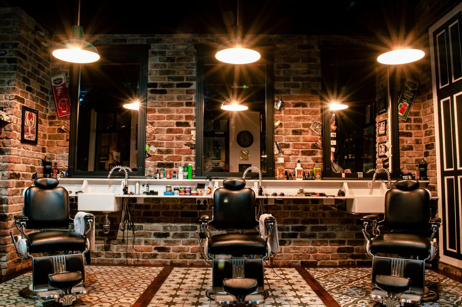 Vintage-style barbershop with exposed brick and three chairs