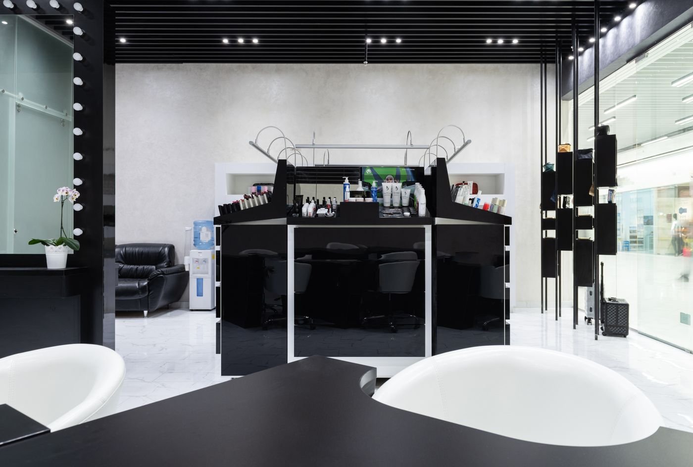 Minimal black reception desk in a salon